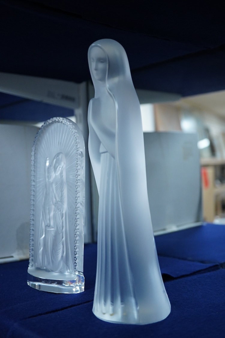 A Lalique ‘Vierge A L’Enfant Agenouille statue’ 20cm high, together with a model of ‘Virgin with hands together’, 25cm high (both boxed)